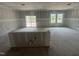 Kitchen in a new construction home with a breakfast bar, sliding glass door, and many windows at 11147 Salers Loop, Middlesex, NC 27557