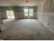 Living room in a new construction home with a sliding glass door and many windows at 11147 Salers Loop, Middlesex, NC 27557