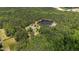 Expansive aerial view captures the home, pond, and surrounding wooded landscape at 1131 Pulley Gordon Rd, Zebulon, NC 27597