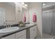 Bathroom features a double vanity with undermount sinks, modern fixtures, and a framed mirror at 1131 Pulley Gordon Rd, Zebulon, NC 27597