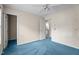 Spacious bedroom featuring blue carpet, ceiling fan, and access to the en-suite bathroom at 1131 Pulley Gordon Rd, Zebulon, NC 27597
