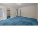 Bright bedroom featuring blue carpeting, white walls and trim, and an ensuite bathroom at 1131 Pulley Gordon Rd, Zebulon, NC 27597