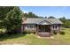 Charming brick home with a cozy front porch and well-maintained landscaping at 1131 Pulley Gordon Rd, Zebulon, NC 27597