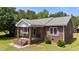 Charming brick home with a cozy front porch and well-maintained landscaping at 1131 Pulley Gordon Rd, Zebulon, NC 27597