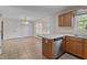 Open kitchen area with a central island, stainless steel appliances, and tile flooring at 1131 Pulley Gordon Rd, Zebulon, NC 27597