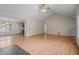 Open living room features wood flooring, vaulted ceilings, and seamless flow to the kitchen at 1131 Pulley Gordon Rd, Zebulon, NC 27597