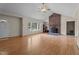 Bright living room featuring a brick fireplace, large windows, and hardwood flooring at 1131 Pulley Gordon Rd, Zebulon, NC 27597