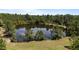 Scenic pond surrounded by lush trees, creating a serene natural landscape at 1131 Pulley Gordon Rd, Zebulon, NC 27597