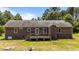 Rear view of the home highlighting a spacious deck and well-manicured lawn at 1131 Pulley Gordon Rd, Zebulon, NC 27597