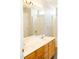 Bathroom with double sinks, wood cabinetry, updated fixtures, and a walk-in shower in the background at 12 Linsey Ct, Lillington, NC 27546