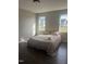 Comfortable bedroom with a large bed, wood-look floors, and abundant natural light from two windows at 12 Linsey Ct, Lillington, NC 27546