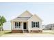 Charming single-story home with a cozy front porch and well-maintained lawn on a sunny day at 12 Linsey Ct, Lillington, NC 27546