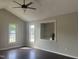 Bright living room with vaulted ceilings, modern ceiling fan and large windows offering plenty of natural light at 12 Linsey Ct, Lillington, NC 27546