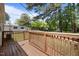 Back deck with wooden railing and lots of room with a grassy backyard at 1208 W Murray Ave, Durham, NC 27704