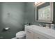 Half-bathroom features a modern vanity, brushed nickel faucet, mirror, and stylish accents at 1208 W Murray Ave, Durham, NC 27704