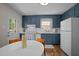 Bright kitchen with blue cabinets, white countertops, and a view to the backyard. Features an eat-in dining area at 1208 W Murray Ave, Durham, NC 27704
