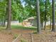 Large backyard of home, view of shed, deck and the lot's natural surroundings at 1220 Sherbrooke Ct, Raleigh, NC 27612