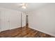 Bedroom with wood-look floors, white trim, and a bright interior at 1220 Sherbrooke Ct, Raleigh, NC 27612