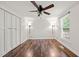 Bedroom features wood-look floors, a ceiling fan, closet, and natural light from the window at 1220 Sherbrooke Ct, Raleigh, NC 27612