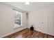 Bright bedroom with wood-look flooring, a window, and a closet on the right side of the room at 1220 Sherbrooke Ct, Raleigh, NC 27612