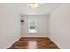 Cozy bedroom with a window, ceiling fan and wood-look floors at 1220 Sherbrooke Ct, Raleigh, NC 27612