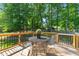 Relax on the deck with the metal table and chairs while enjoying the beauty of nature at 1220 Sherbrooke Ct, Raleigh, NC 27612