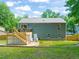 Beautiful backyard showcasing the deck, patio, and backyard with green grass at 1220 Sherbrooke Ct, Raleigh, NC 27612