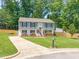 Landscaped front yard with a split-level home, long driveway, and storage building at 1220 Sherbrooke Ct, Raleigh, NC 27612