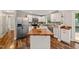 Bright kitchen with white cabinets, stainless appliances, and butcher block island at 1220 Sherbrooke Ct, Raleigh, NC 27612