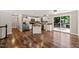 Open-concept kitchen features stainless steel appliances, white cabinets, wood floors, and access to outdoor deck at 1220 Sherbrooke Ct, Raleigh, NC 27612