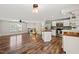 Spacious open concept living and kitchen area with wood flooring and natural light at 1220 Sherbrooke Ct, Raleigh, NC 27612