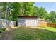 The backyard includes a convenient storage shed, surrounded by a fenced yard and manicured lawn at 1220 Sherbrooke Ct, Raleigh, NC 27612