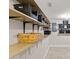 Basement storage area with open shelves and wood paneled walls at 1220 Sherbrooke Ct, Raleigh, NC 27612