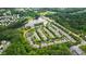 An aerial view of a residential community with a pond and lush green trees surrounding the homes at 1231 Silver Beach Way, Raleigh, NC 27606