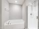 Bright bathroom showcasing a soaking tub and shower with glass enclosure, and chrome fixtures at 1231 Silver Beach Way, Raleigh, NC 27606
