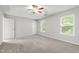 Spacious bedroom with natural light, carpet flooring, ceiling fan and two windows at 1231 Silver Beach Way, Raleigh, NC 27606