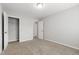 Spacious carpeted bedroom featuring a closet and white trim with natural light at 1231 Silver Beach Way, Raleigh, NC 27606