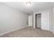 Comfortable bedroom with carpeted floors and a closet with sliding doors at 1231 Silver Beach Way, Raleigh, NC 27606