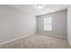 Carpeted bedroom with neutral walls and a window providing natural light at 1231 Silver Beach Way, Raleigh, NC 27606