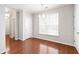 Bright dining room with hardwood floors, a window with blinds, and a simple chandelier at 1231 Silver Beach Way, Raleigh, NC 27606