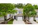 Charming townhome featuring a two-car garage, blue shutters, and a well-manicured lawn at 1231 Silver Beach Way, Raleigh, NC 27606