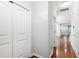 Bright hallway with hardwood floors, neutral paint, closet, and doorways leading to other rooms at 1231 Silver Beach Way, Raleigh, NC 27606