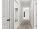 Bright hallway featuring carpet flooring and white doors leading to bedrooms and bathrooms at 1231 Silver Beach Way, Raleigh, NC 27606