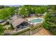 Aerial view of a community pool, grilling station, and lounge area surrounded by lush greenery at 1231 Silver Beach Way, Raleigh, NC 27606