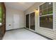 Covered screened porch with sliding glass door, white door, and wooded scenery at 1231 Silver Beach Way, Raleigh, NC 27606