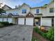 Inviting townhouse exterior with stone accents, attached garages, and landscaped front yard at 1309 Bartlett Cir, Hillsborough, NC 27278