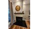 Elegant fireplace with white shiplap, wooden mantel, and decor at 1309 Bartlett Cir, Hillsborough, NC 27278