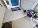 Cozy front entrance featuring stylish tile flooring and a vibrant flower arrangement, enhancing curb appeal at 1309 Bartlett Cir, Hillsborough, NC 27278