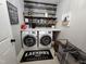 Charming laundry room with front loading washer and dryer, decorated with rustic shelving and decor at 1309 Bartlett Cir, Hillsborough, NC 27278