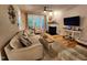 Cozy living room features a fireplace, ceiling fan, and stylish, comfortable furnishings at 1309 Bartlett Cir, Hillsborough, NC 27278